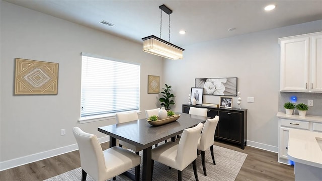 dining area featuring dark wood-type flooring