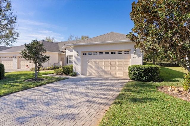 view of front of home featuring a front lawn and a garage