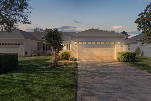 view of front of property with a yard and a garage