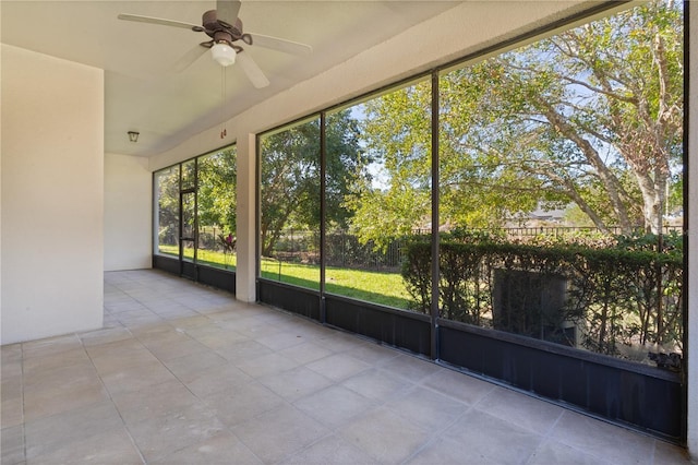 unfurnished sunroom featuring ceiling fan