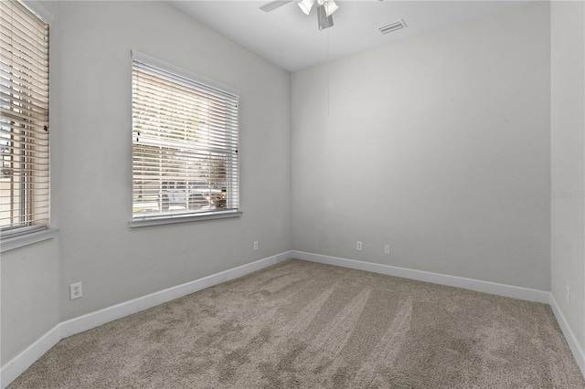 unfurnished room with ceiling fan and carpet floors