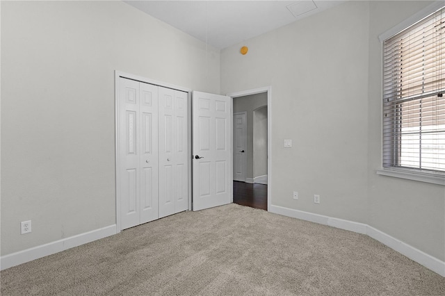 unfurnished bedroom with a closet and carpet