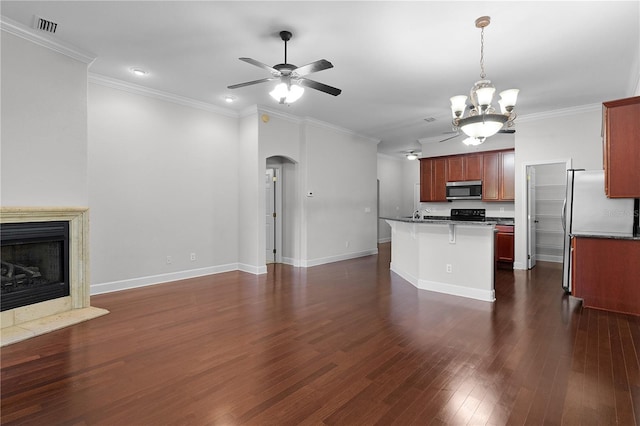 kitchen with dark hardwood / wood-style floors, pendant lighting, a kitchen bar, ceiling fan with notable chandelier, and ornamental molding