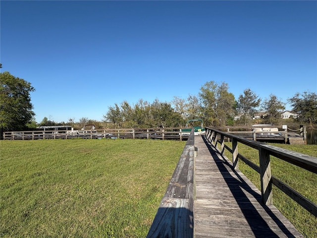 exterior space with a rural view, a lawn, and fence