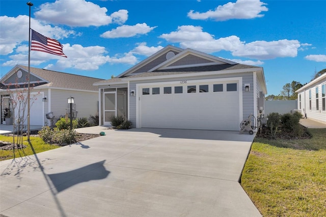 view of front of home with a garage and a front lawn