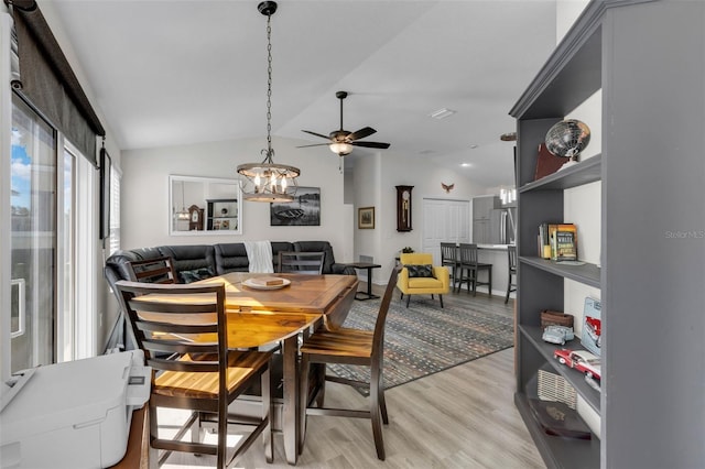 dining area featuring ceiling fan, light hardwood / wood-style floors, and lofted ceiling