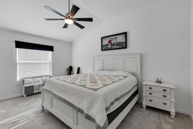 carpeted bedroom with ceiling fan and lofted ceiling