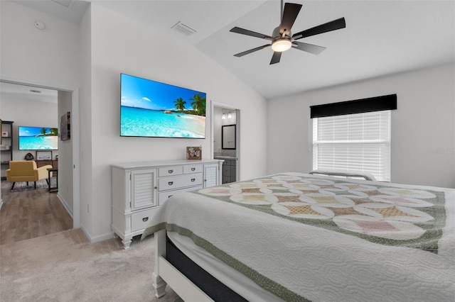 carpeted bedroom featuring connected bathroom, ceiling fan, and vaulted ceiling