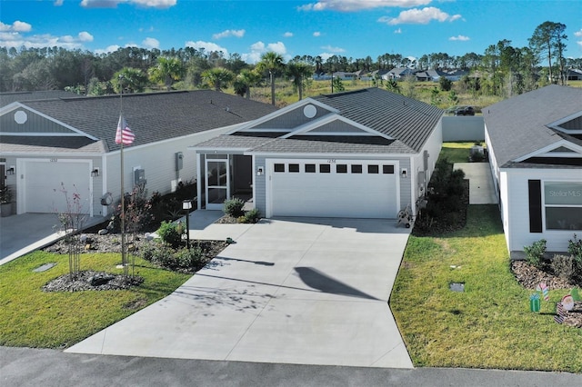 ranch-style house featuring a front lawn and a garage