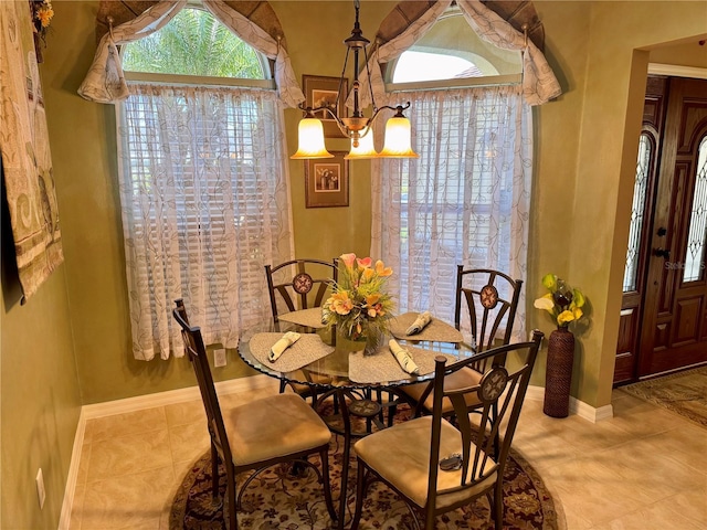 dining area featuring a notable chandelier and light tile patterned floors