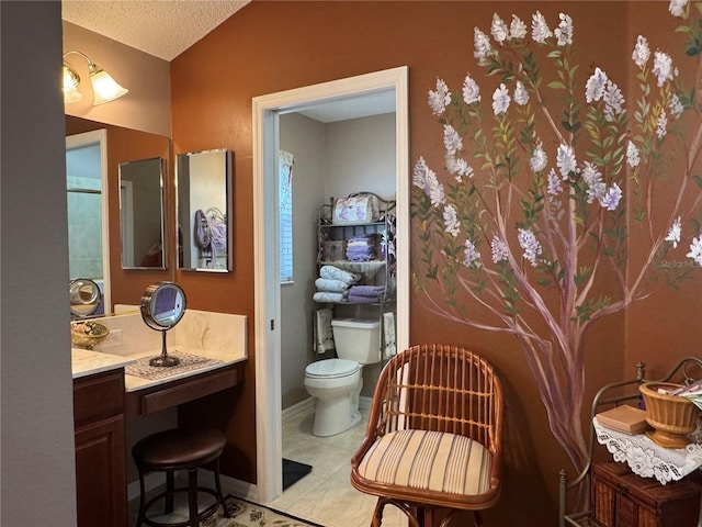 bathroom with vaulted ceiling, tile patterned flooring, a textured ceiling, and toilet