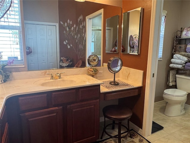 bathroom with tile patterned floors, vanity, and toilet