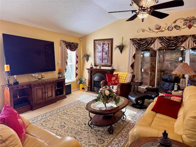 carpeted living room featuring a textured ceiling, vaulted ceiling, and ceiling fan