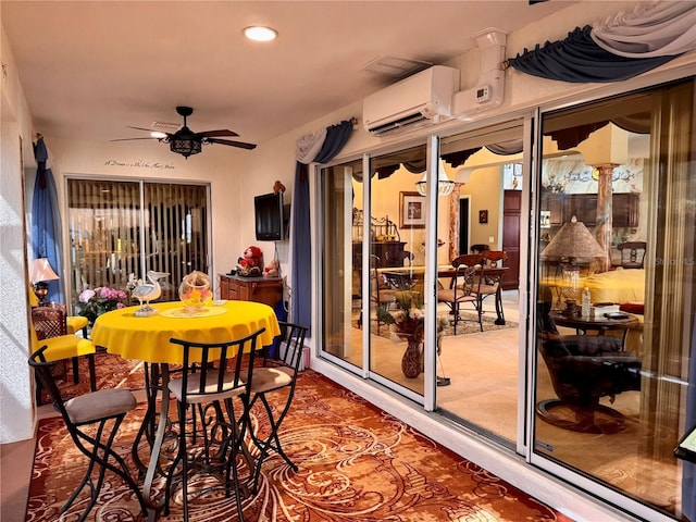 interior space with a wall mounted air conditioner and ceiling fan