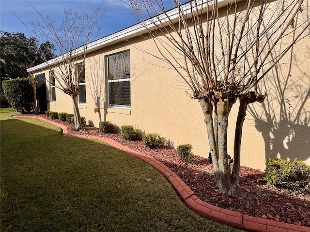 view of side of property with a yard