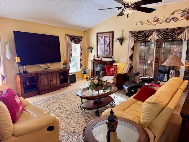 living room featuring vaulted ceiling, ceiling fan, and a textured ceiling