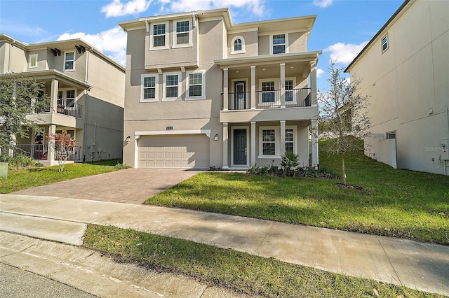 view of front of property with a front yard and a garage