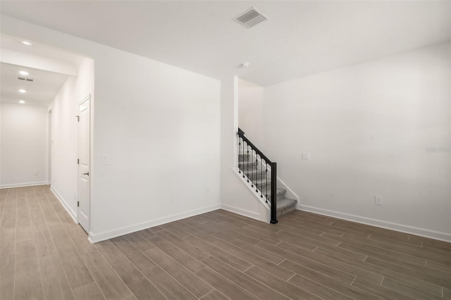 unfurnished room with dark wood-type flooring