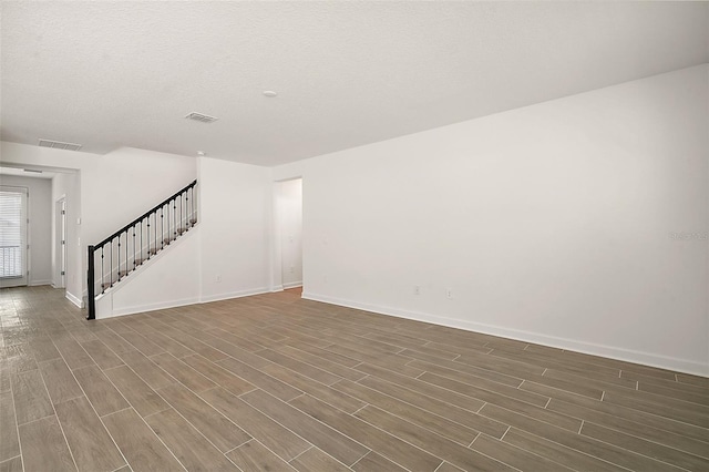 unfurnished living room featuring a textured ceiling