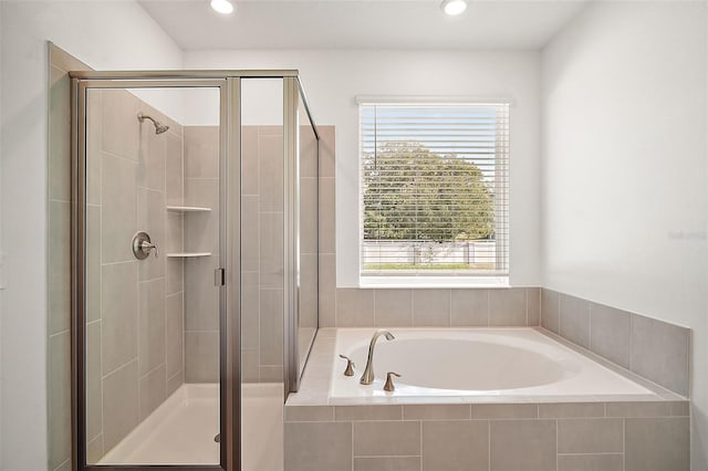 bathroom featuring separate shower and tub