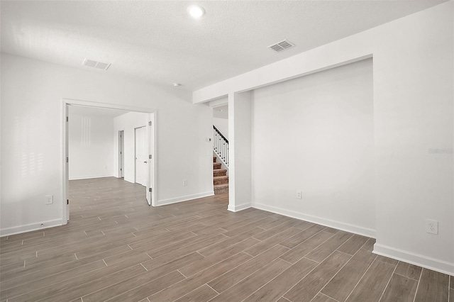 unfurnished room featuring a textured ceiling