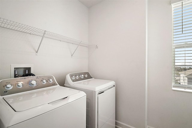 clothes washing area with separate washer and dryer