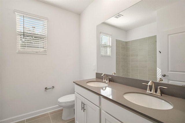 bathroom with tile patterned flooring, vanity, and toilet