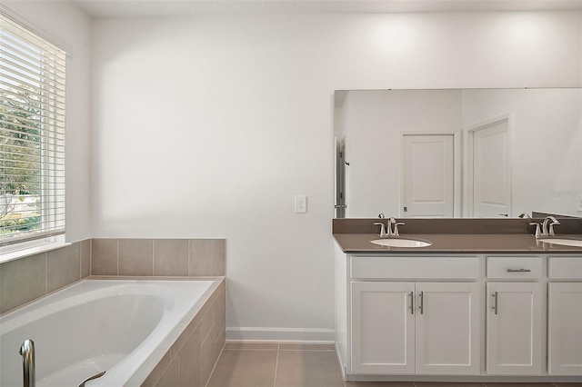 bathroom featuring vanity, tiled bath, and tile patterned floors