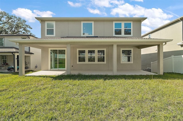 rear view of property with a patio and a yard