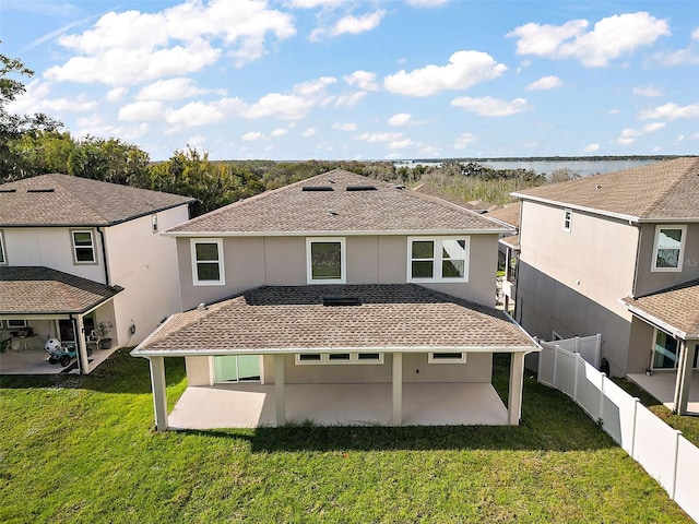 back of property featuring a patio and a lawn