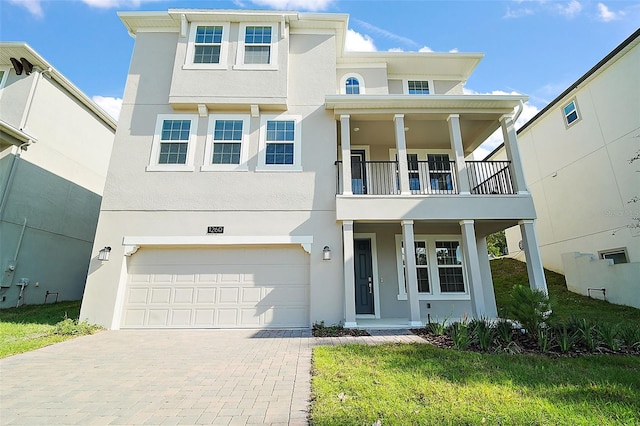 view of front facade with a balcony and a garage