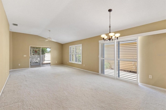 empty room featuring ceiling fan with notable chandelier, lofted ceiling, and light carpet