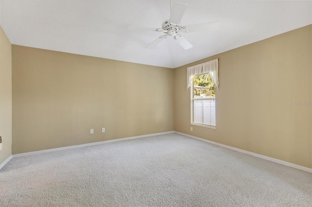 carpeted spare room with ceiling fan