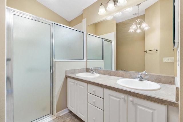 bathroom featuring a notable chandelier, a shower with shower door, vanity, and vaulted ceiling