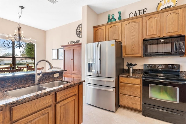 kitchen with sink, a notable chandelier, dark stone counters, decorative light fixtures, and black appliances