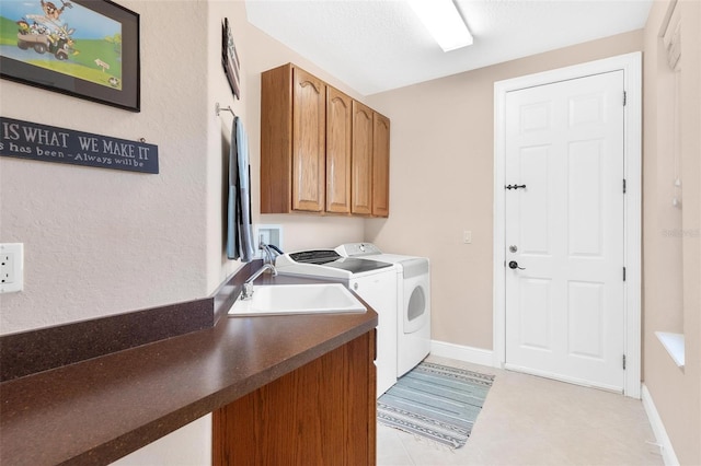 washroom with washing machine and dryer, sink, and cabinets