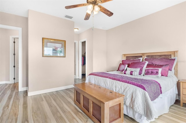 bedroom with ceiling fan and light wood-type flooring