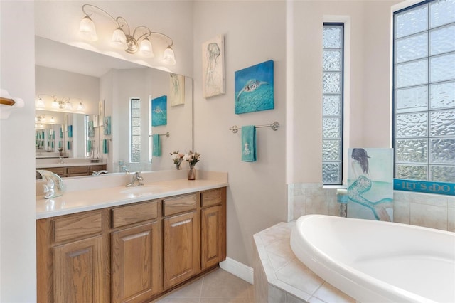 bathroom featuring vanity, a relaxing tiled tub, and tile patterned floors