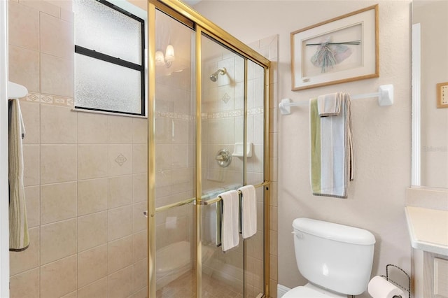 bathroom featuring vanity, toilet, and an enclosed shower