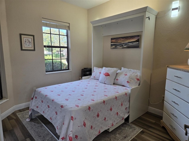 bedroom featuring dark hardwood / wood-style flooring