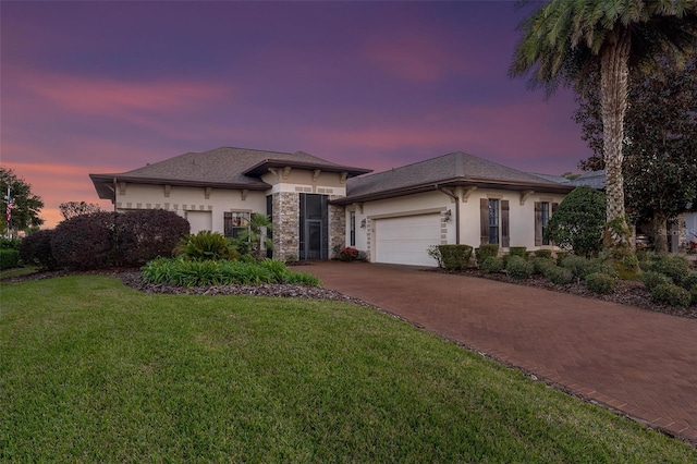 view of front of house with a yard and a garage