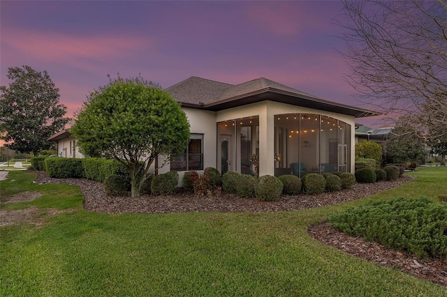 exterior space with a lawn and a sunroom