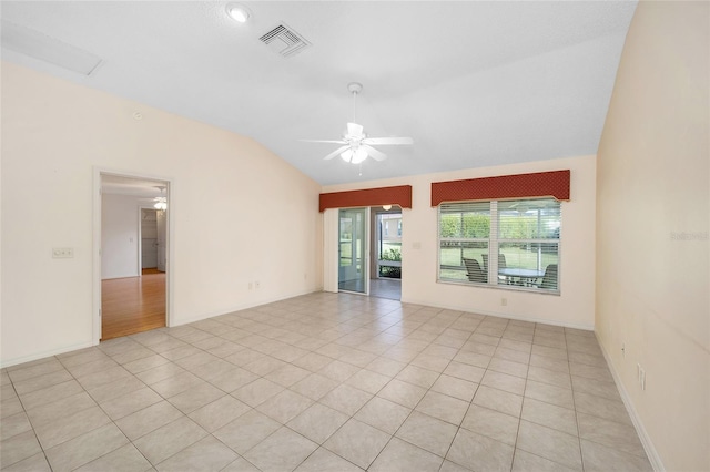 spare room with ceiling fan, light tile patterned flooring, and lofted ceiling