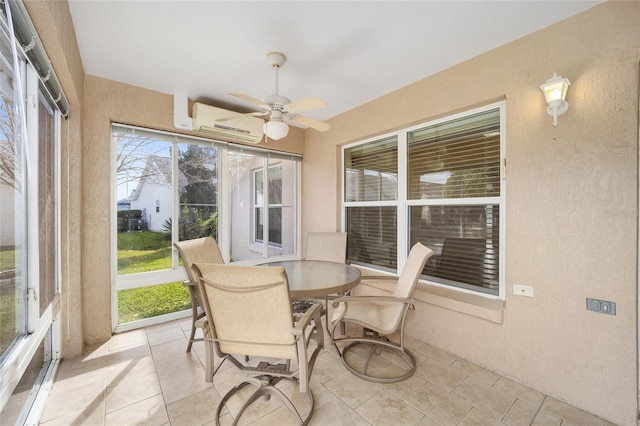 sunroom / solarium featuring a wall unit AC and ceiling fan