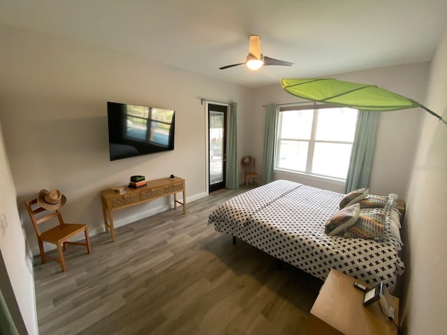 bedroom featuring hardwood / wood-style flooring and ceiling fan