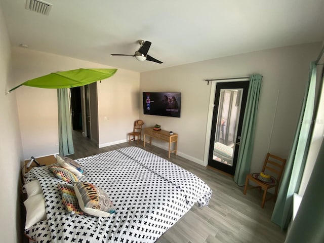 bedroom with ceiling fan, wood-type flooring, and access to exterior