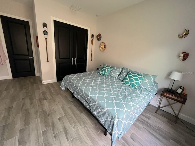 bedroom with wood-type flooring