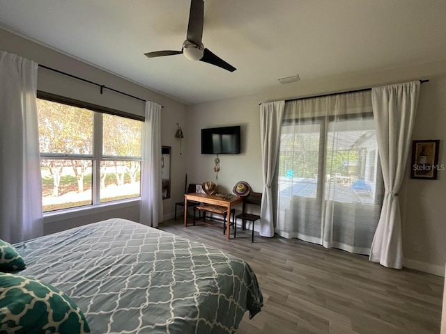 bedroom featuring wood-type flooring, ceiling fan, and access to outside