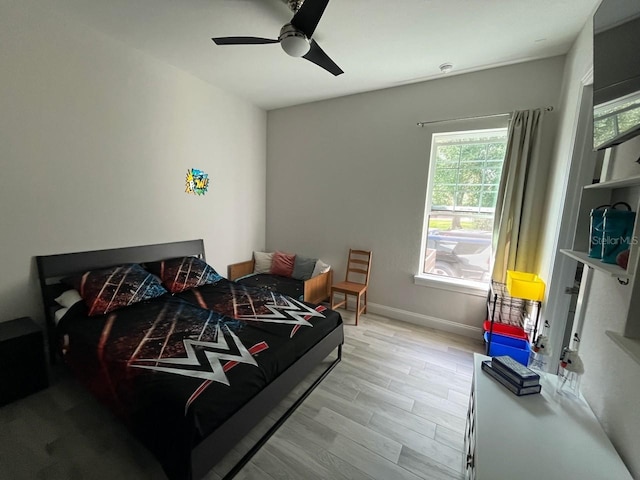 bedroom with light hardwood / wood-style floors and ceiling fan