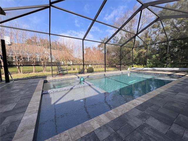 view of pool with a patio and glass enclosure